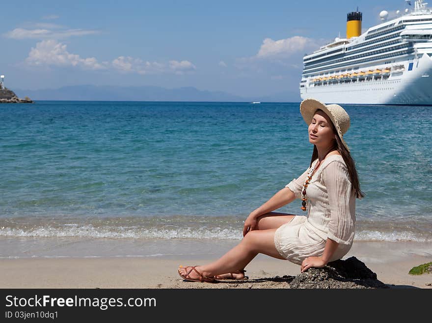Beautiful woman in a bonnet at the sea beach, Greece