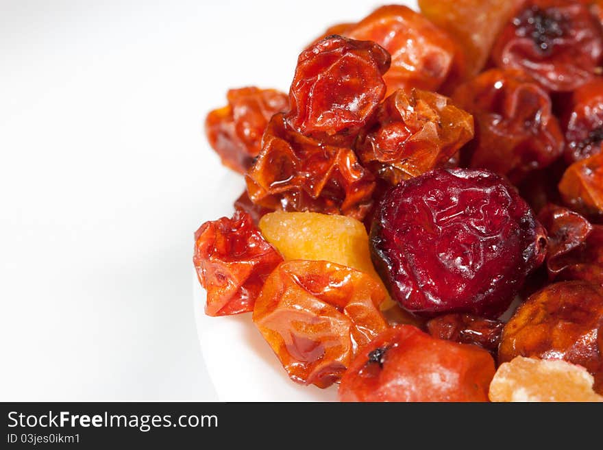 Some kinds of candied fruits on a light surface close up. Some kinds of candied fruits on a light surface close up.