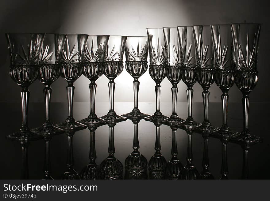 Crystal wine glass composition on the black background. Crystal wine glass composition on the black background