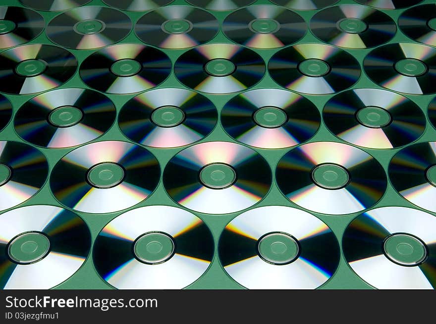 Pattern of CDs on green background. Pattern of CDs on green background