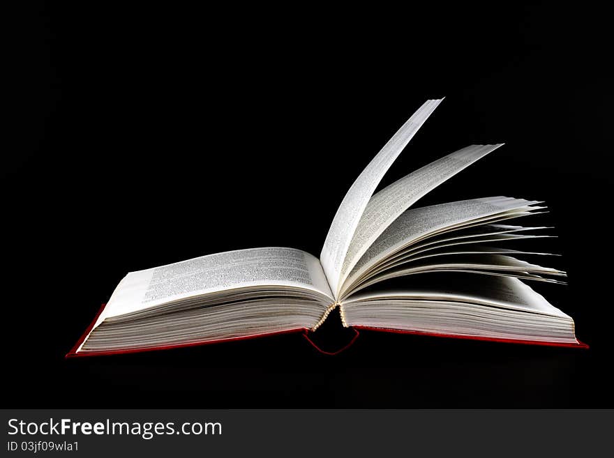 The book, on a dark background in the studio. The book, on a dark background in the studio.