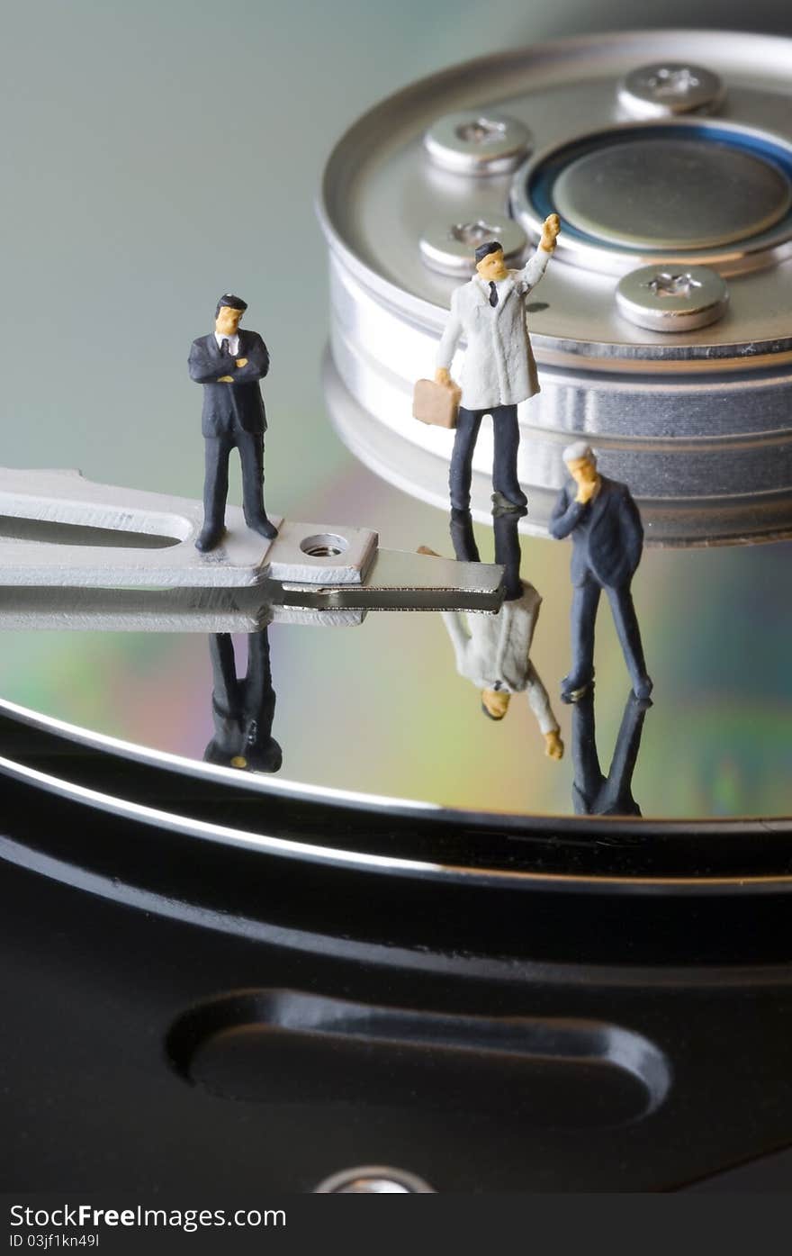 Three business man figures on hard disk. Three business man figures on hard disk