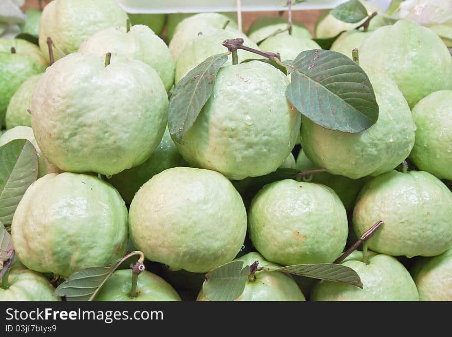 Fresh guavas with green leaf in fruit market.