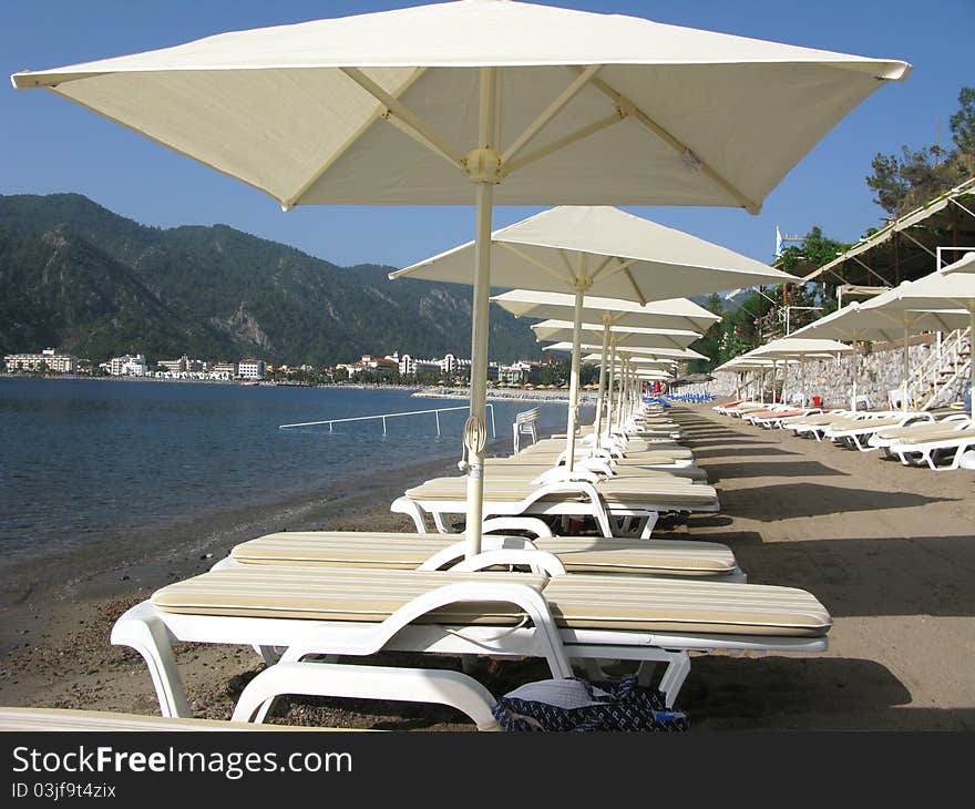 Sandy beach with sun-tents ans sun-beds. Sandy beach with sun-tents ans sun-beds