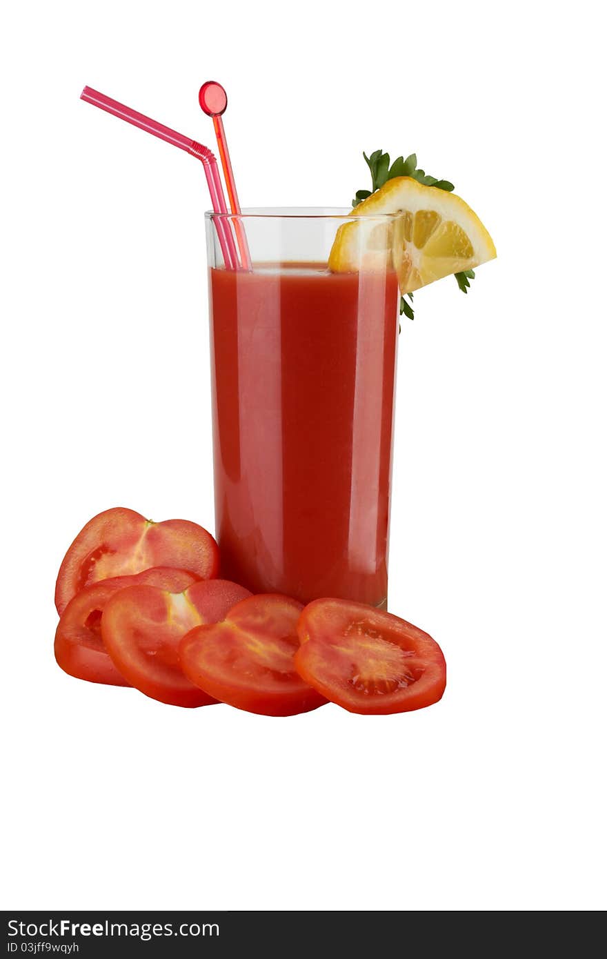 Fresh tomatoes and a glass full of tomato juice.