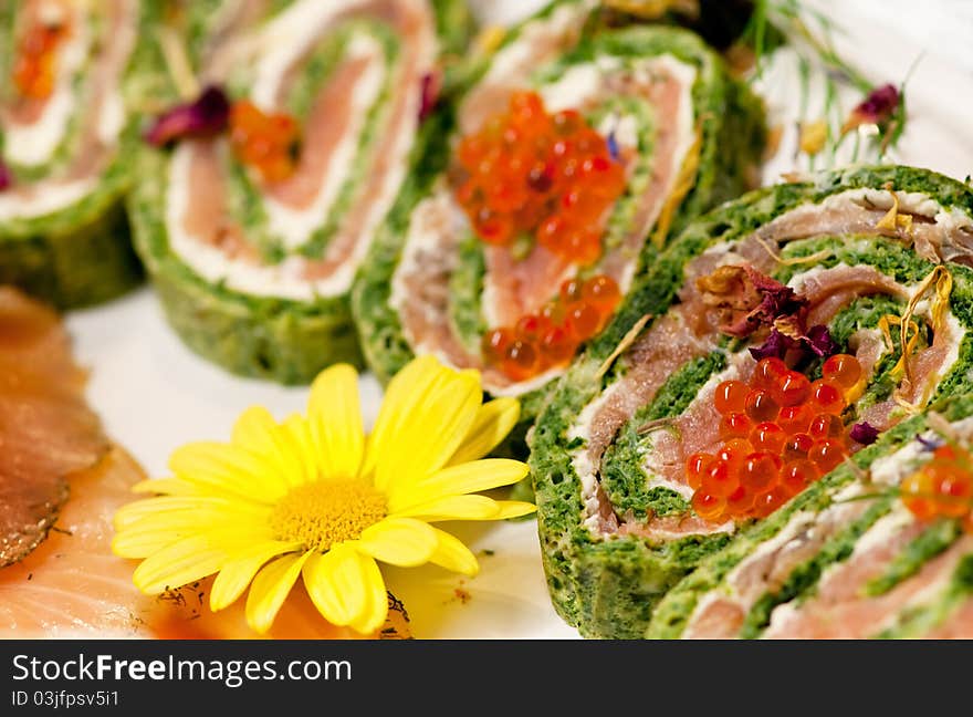 Baked pastries with red pepper, caviar and spinach