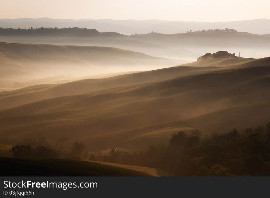 Foggy morning during sunrise in the tuscan hills near Siena