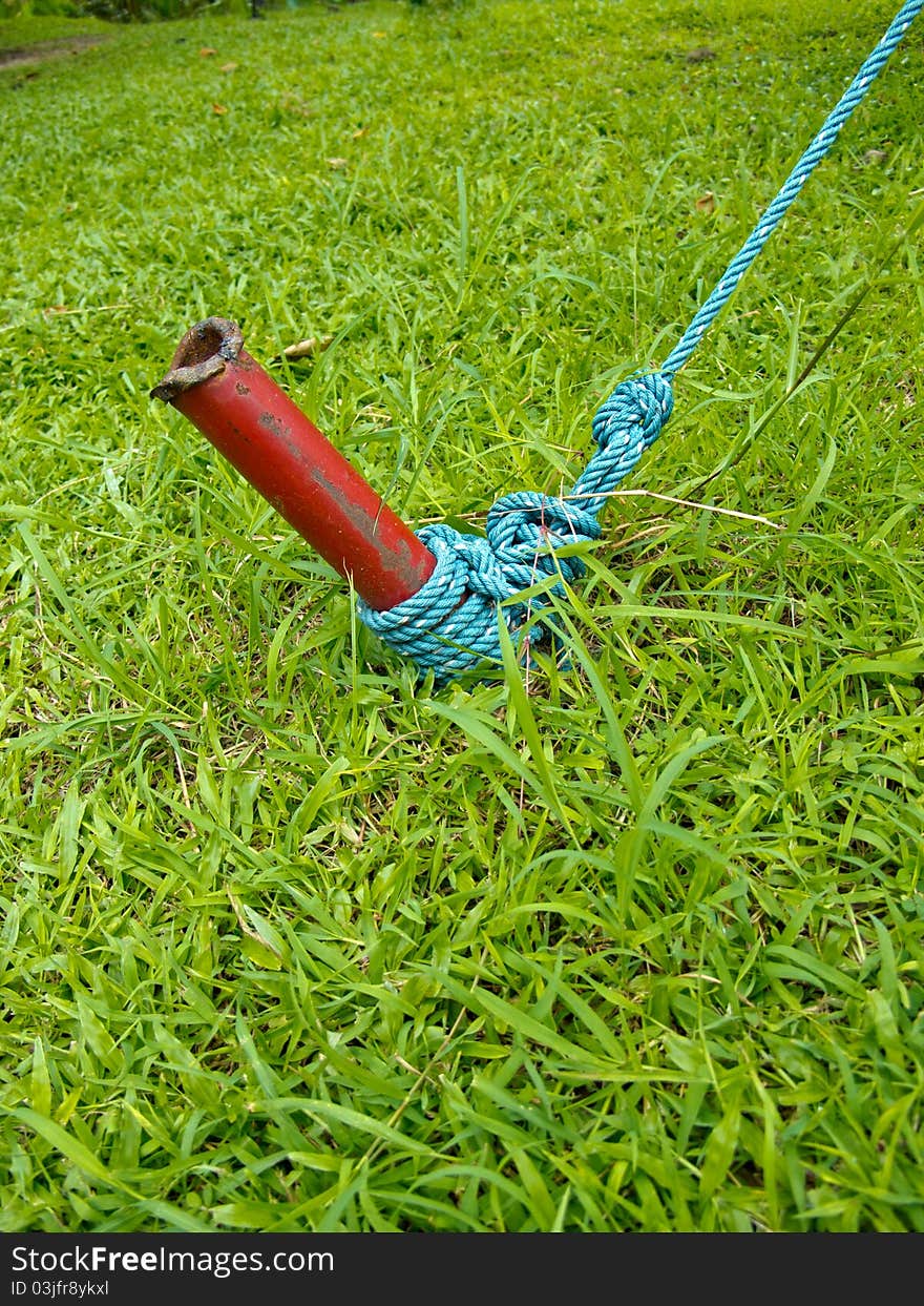 Red iron post and blue knot.