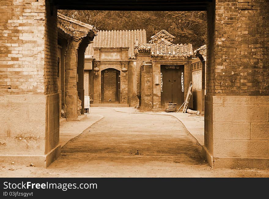 Traditional Chinese alley in Beijing.It has more than 100 years of history. Chinese characters on both sides of door are Chinese couplet.