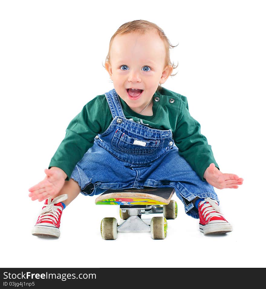 Cute 1 years old boy on a skateboard in the studio. Cute 1 years old boy on a skateboard in the studio