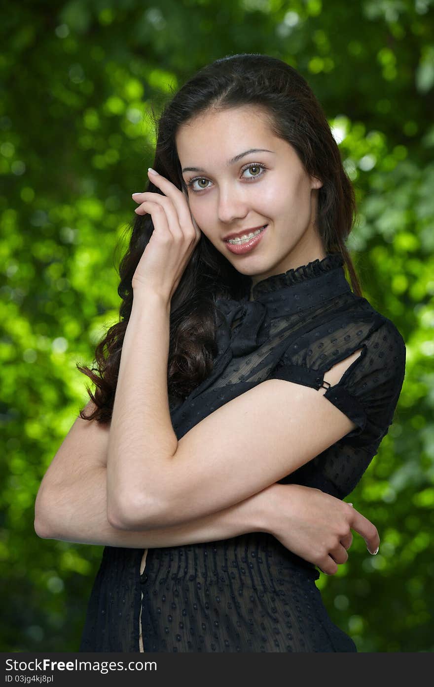 Model girl with braces on a background of trees. Model girl with braces on a background of trees