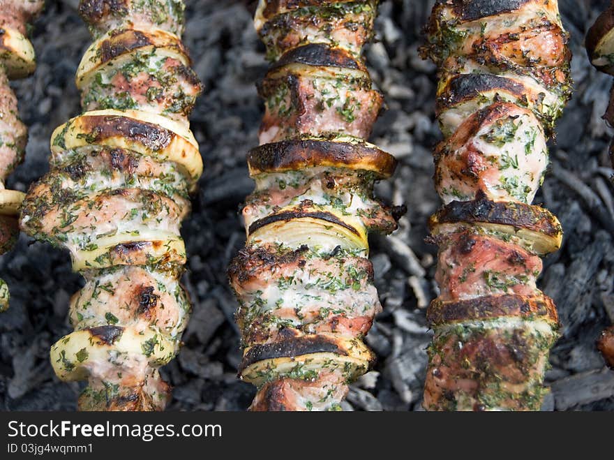 Tasty shish kebab shashlik meat on skewer on coal