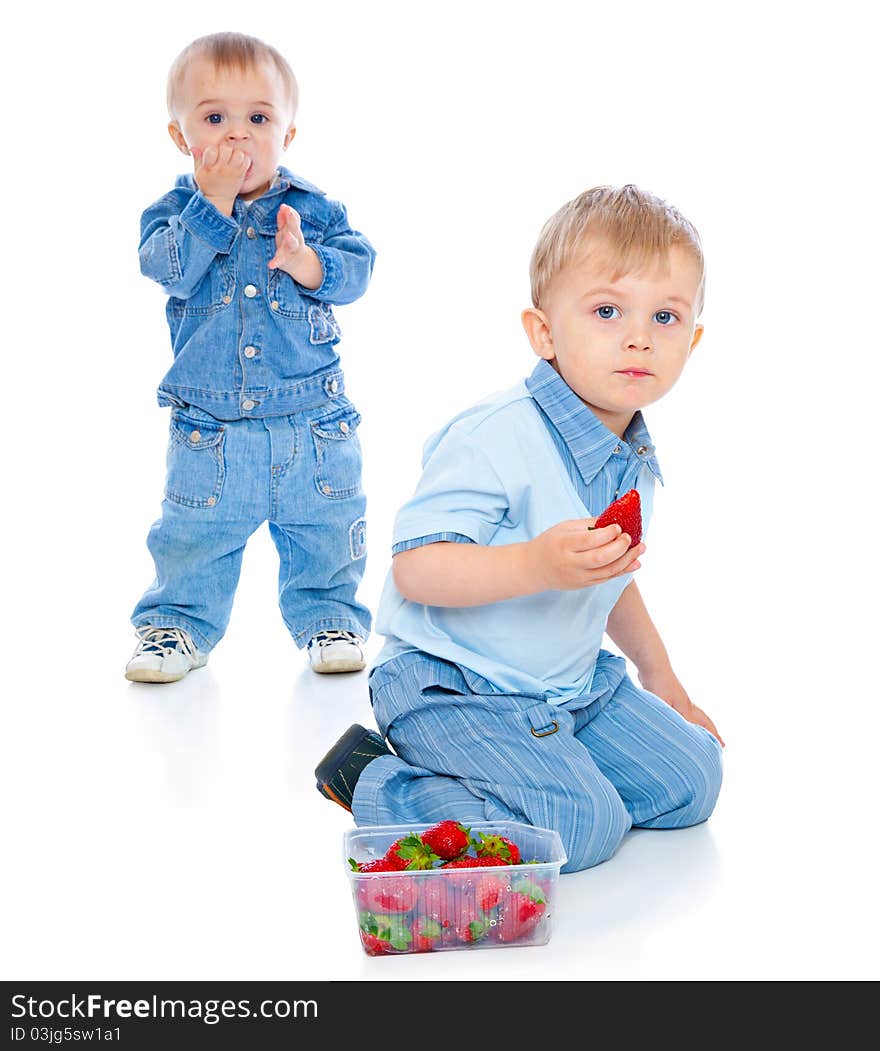 Two brothers with strawberry. Isolated on white background