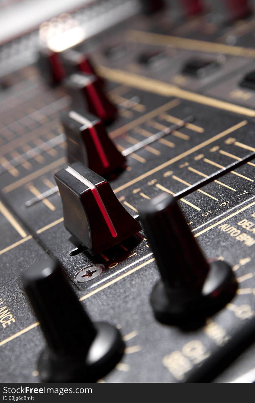 Faders on professional mixing controller