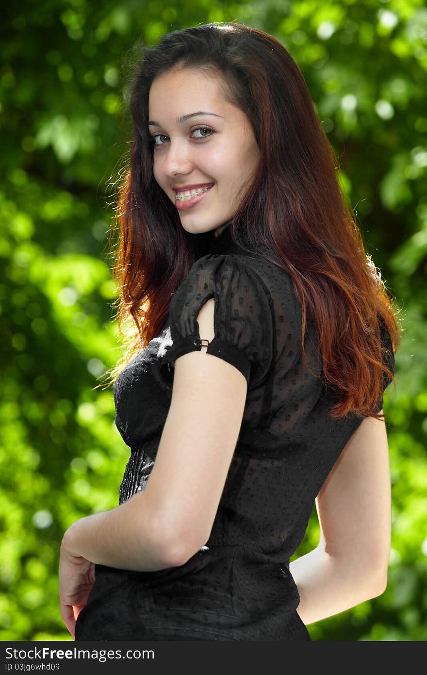 Model girl with braces on a background of trees. Model girl with braces on a background of trees