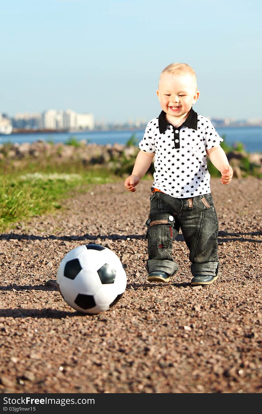 Young smile boy play football