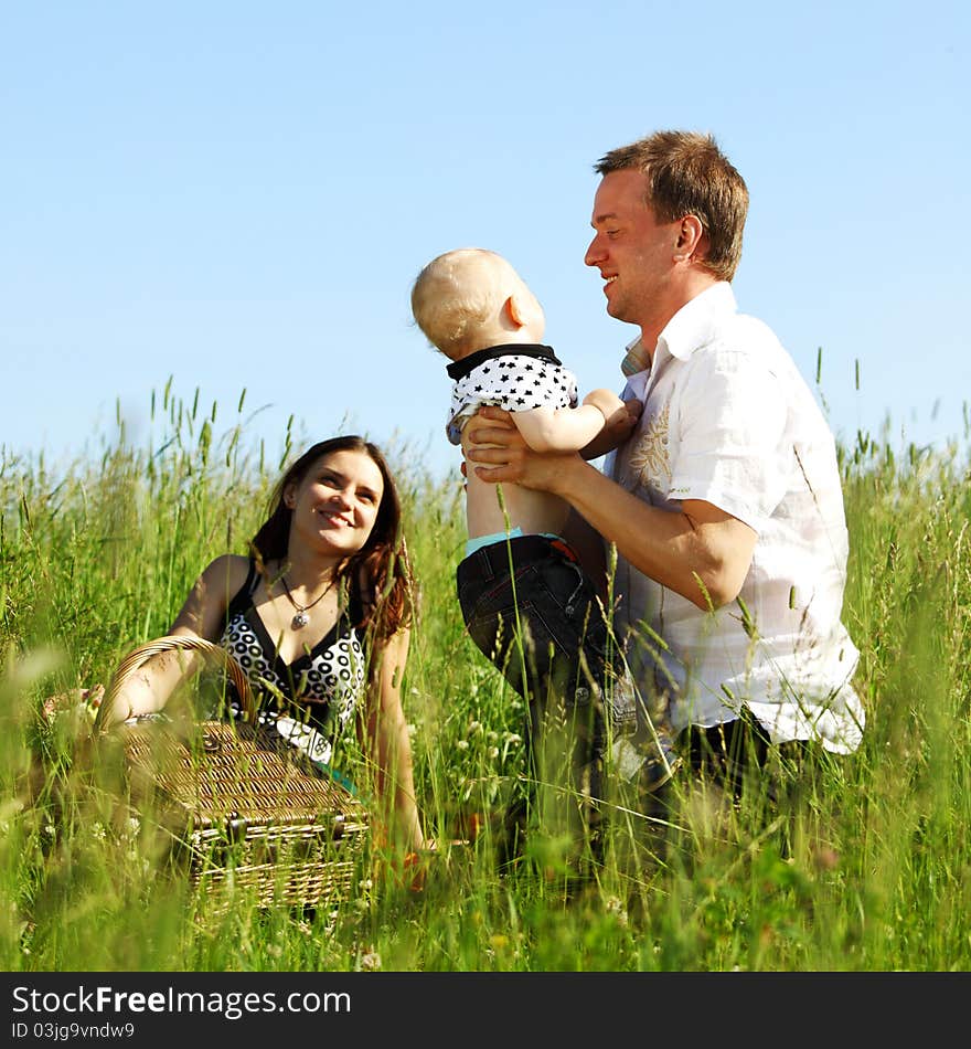 Happy family on green field