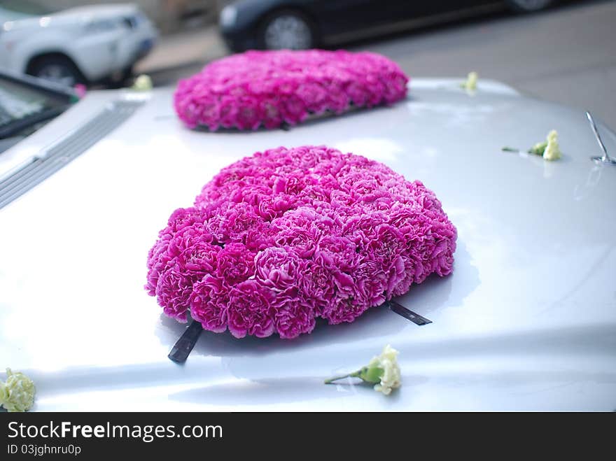 Flowers on a red wedding car. Flowers on a red wedding car