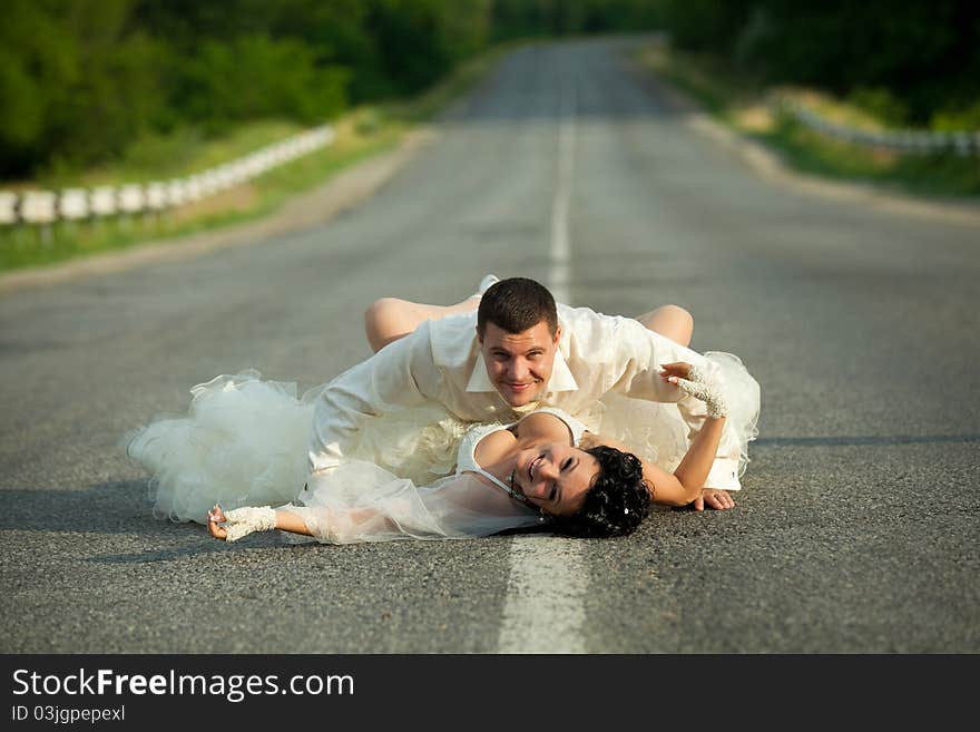 Bride and groom on countryside road