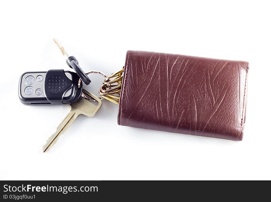 Car alarm key, car key and its wallet (on white background). Car alarm key, car key and its wallet (on white background).
