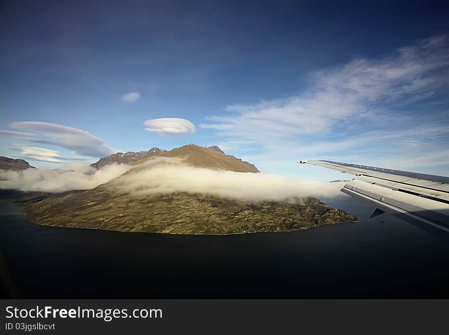 One of the mountains along side the lake in Queenstown. Scenery taken during flights to Queenstown, New Zealand. One of the mountains along side the lake in Queenstown. Scenery taken during flights to Queenstown, New Zealand