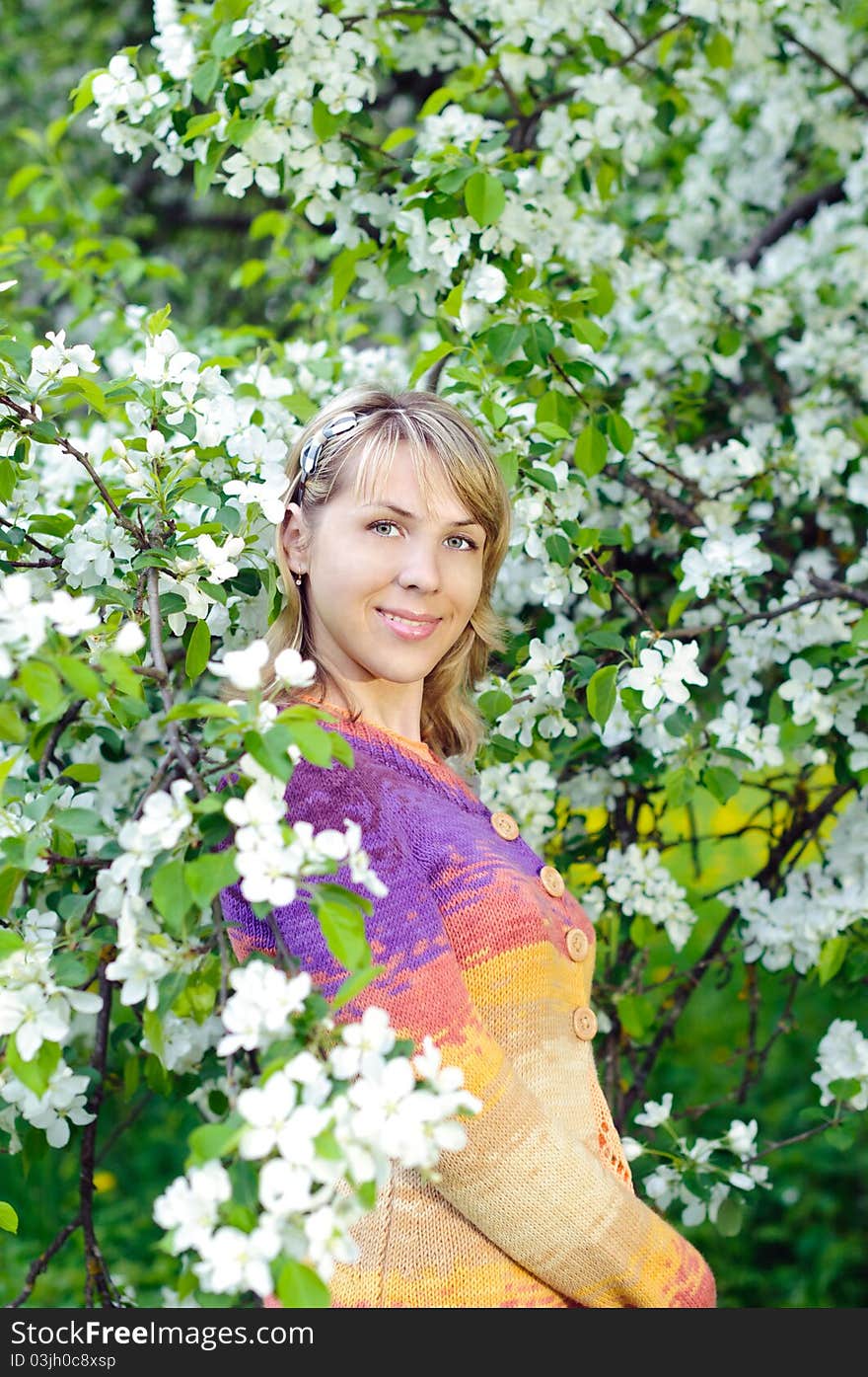 Woman near the blooming tree