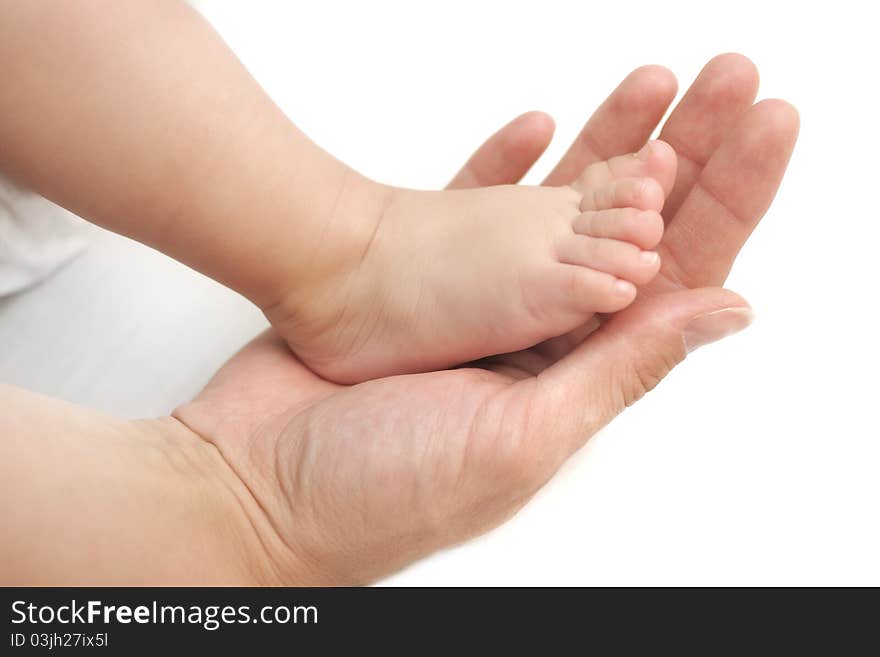 Little baby feet in mommy's hands, isolated white backround