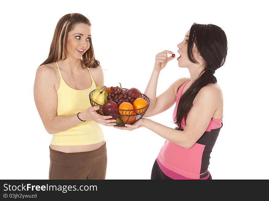 Two women being healthy eating fruit. Two women being healthy eating fruit.