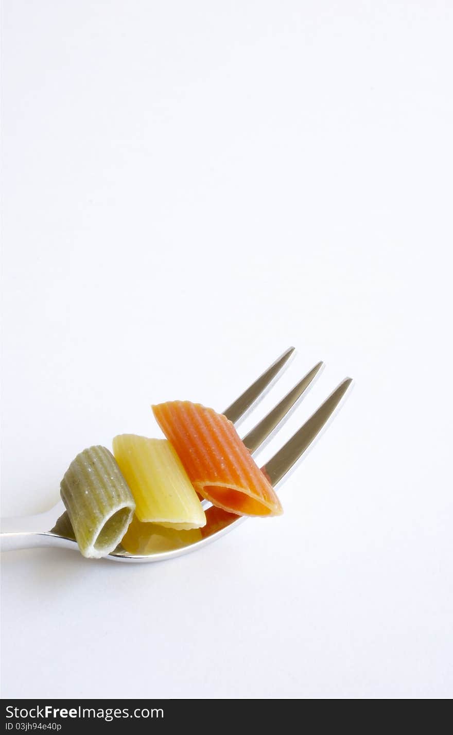 Penne rigate pasta on fork, isolated on white background.