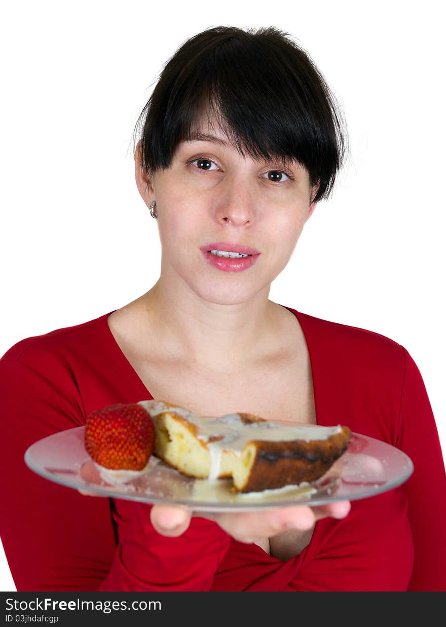 The young girl offers a pie with a strawberry on a plate