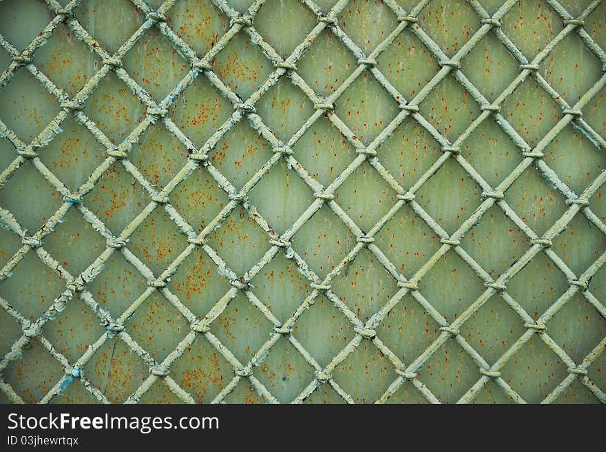 Old metal grill fence with peeling paint