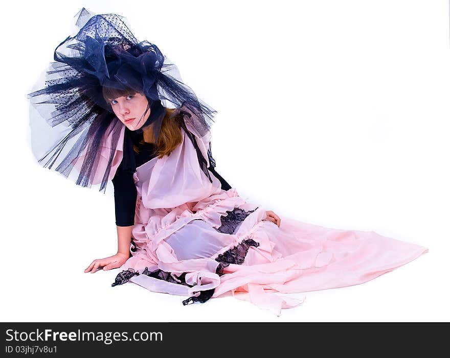 Girl in theatrical costume sitting over white