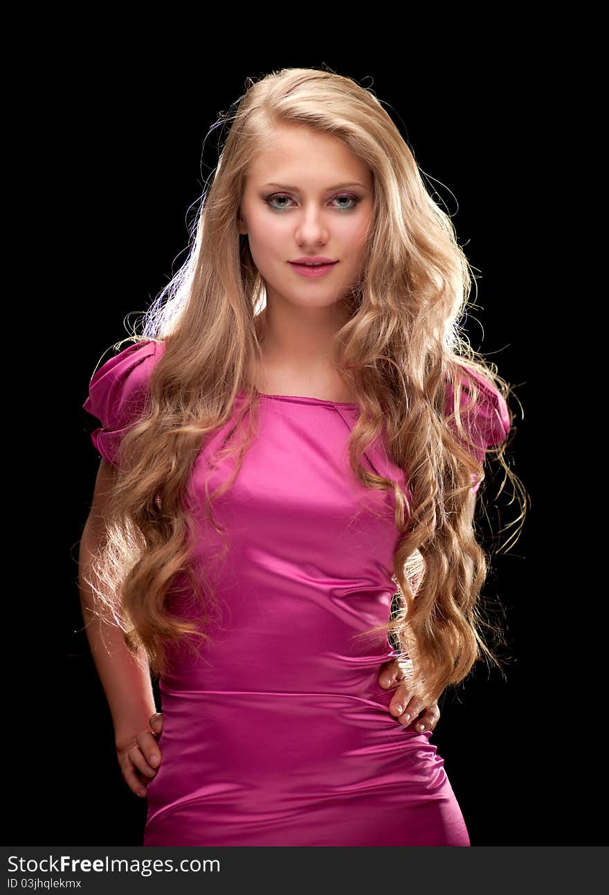 Young woman with beautiful blonde hair on a black background