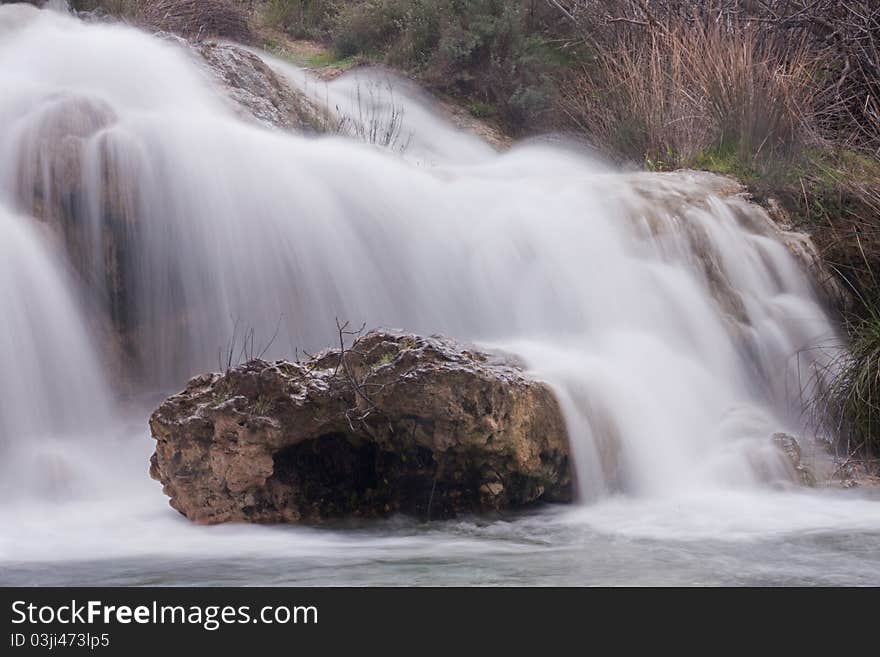 A view of a waterfall between two gaps. A view of a waterfall between two gaps