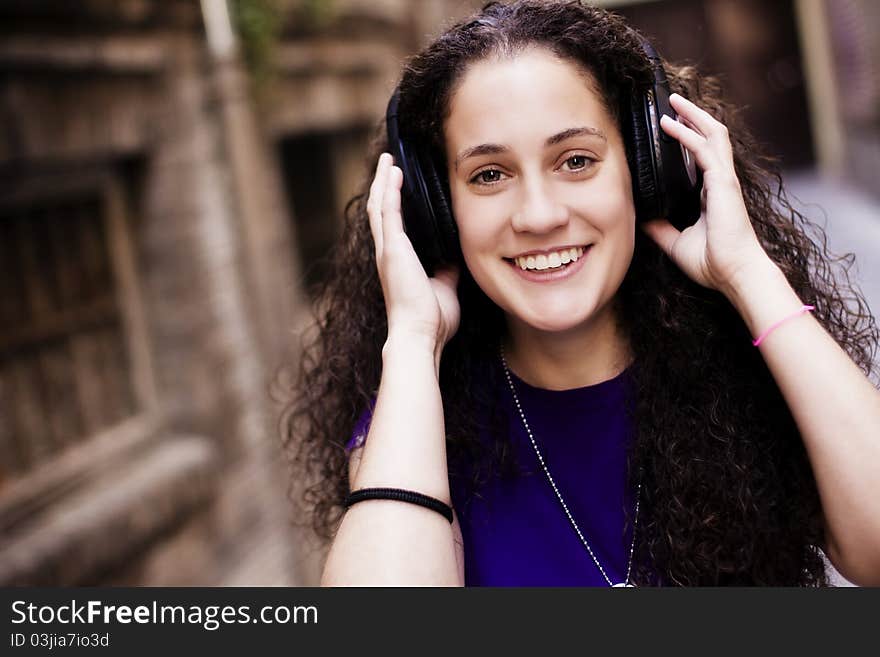 Young beautiful girl enjoying music from her headphones. Young beautiful girl enjoying music from her headphones.