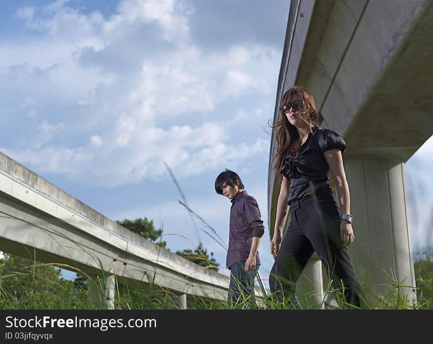 Asian Couple walking near rail track