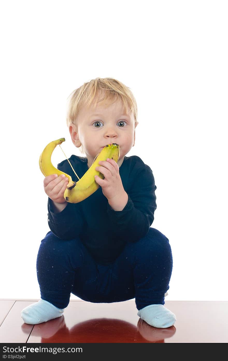 Two years old boy with banana on white. Two years old boy with banana on white