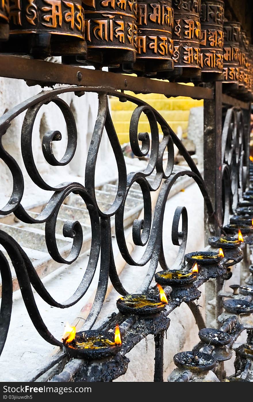 Buddhist prayer wheels and candles in Nepal