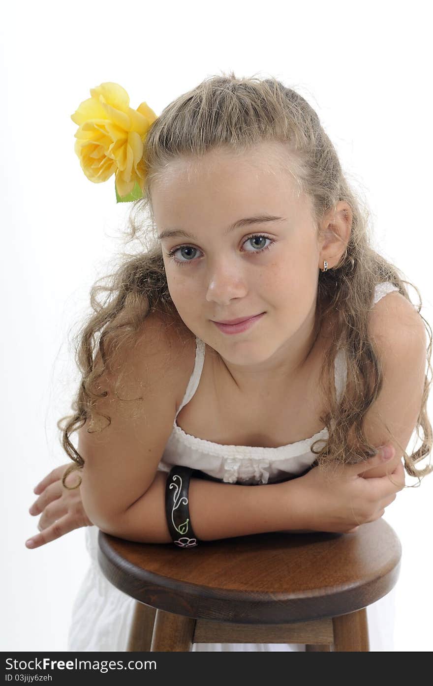 White beautiful child posing with yellow rose in studio. White beautiful child posing with yellow rose in studio