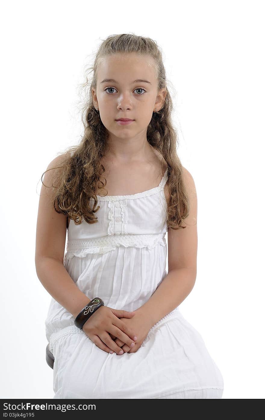 Serious girl posing near chair