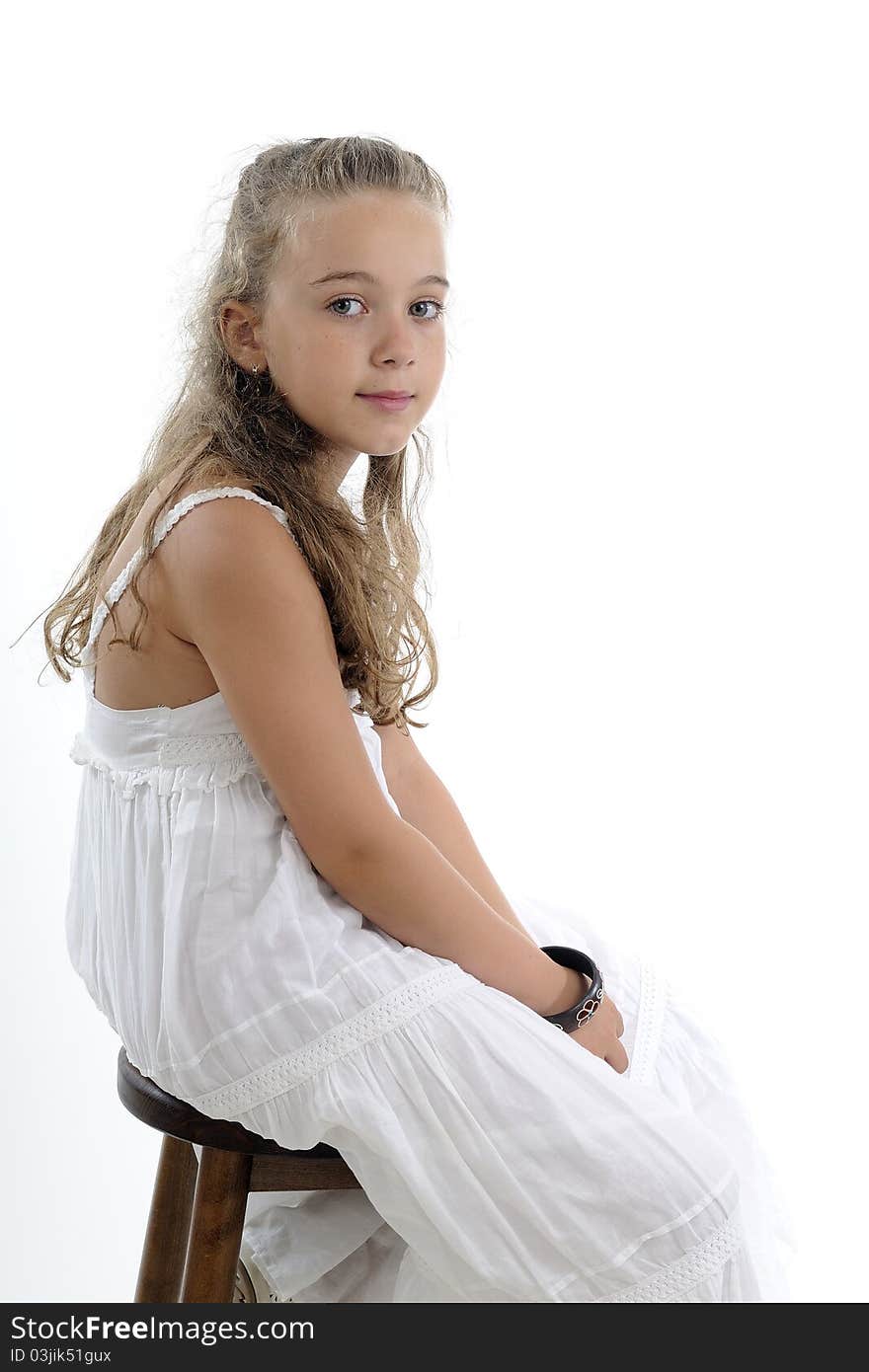 Blonde girl posing near chair