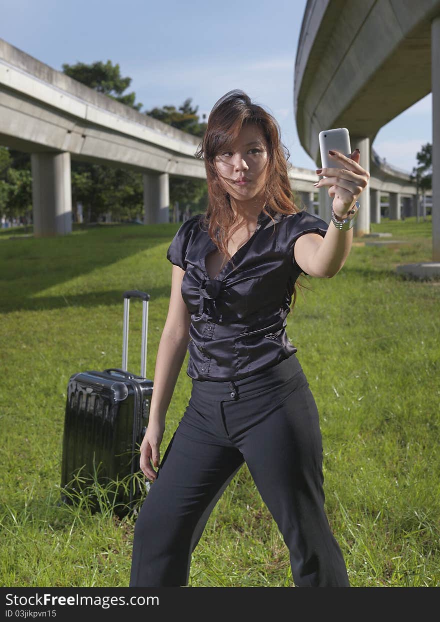 Asian Chinese girl posing cooly in front of tracks