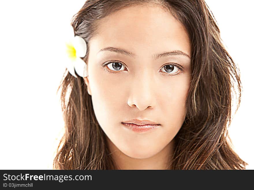 Beautiful asian female face with big eyes and flower from ear isolated on white. Beautiful asian female face with big eyes and flower from ear isolated on white