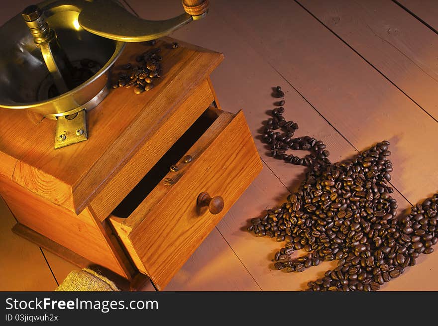 Coffee grinder and coffee beans on the table. Coffee grinder and coffee beans on the table