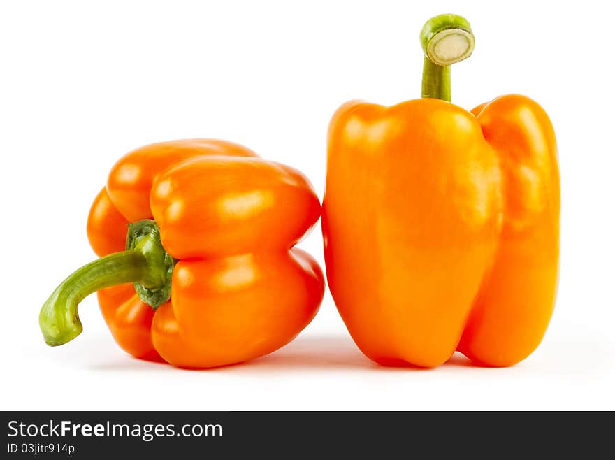 Two orange paprikas on white background