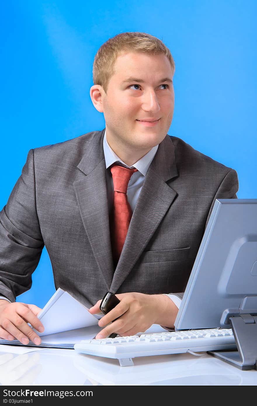 Young successful business man with a document case and computer