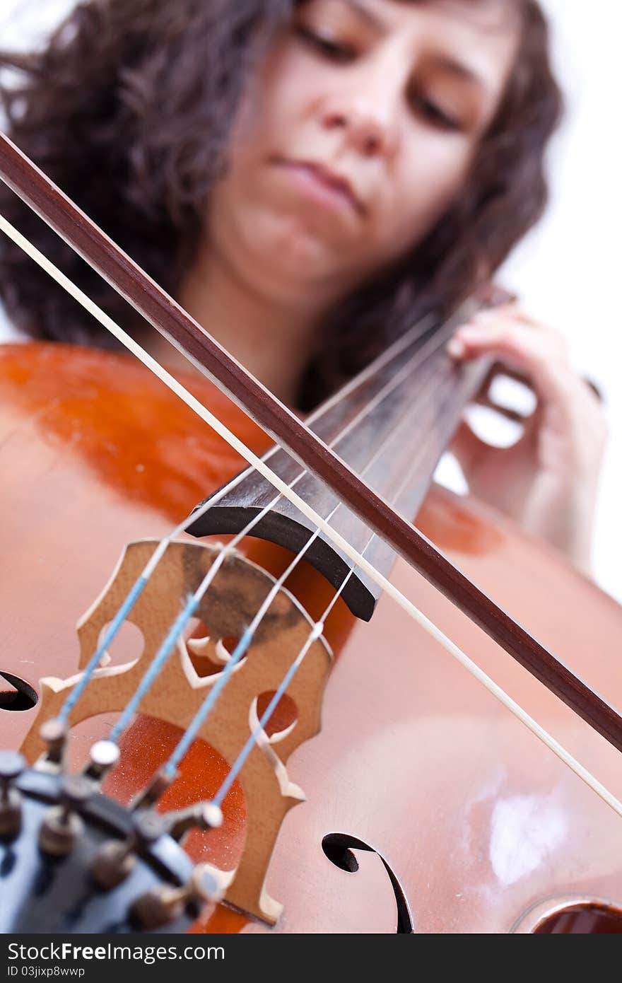 Girl playing cello, studio shot over white background