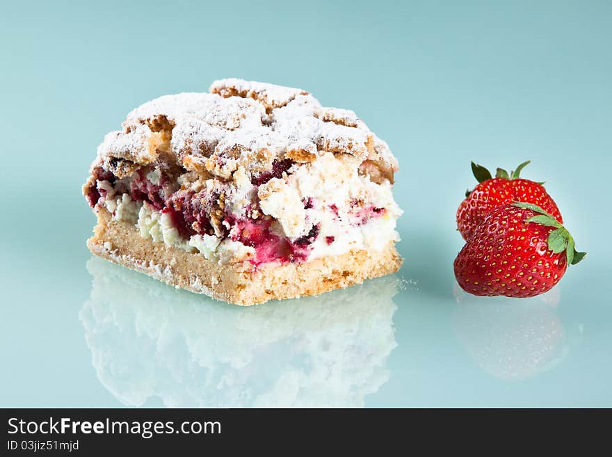 Strawberry cake, with poudding,lies on glass countertrop