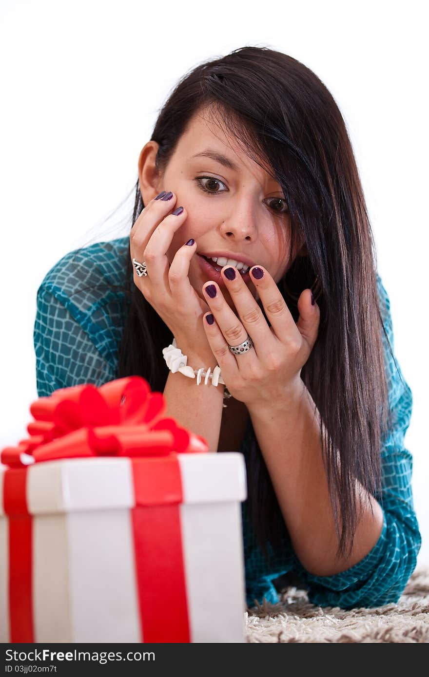 Woman lying on the floor and smiling with gift box. Woman lying on the floor and smiling with gift box