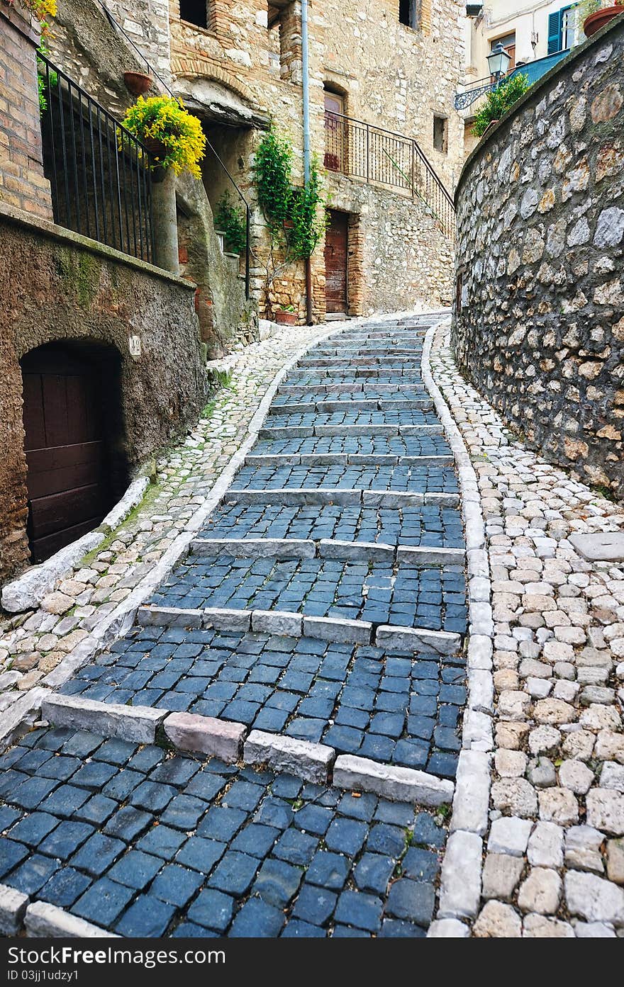 Sidewalk between old homes paved with the cobblestones. Sidewalk between old homes paved with the cobblestones